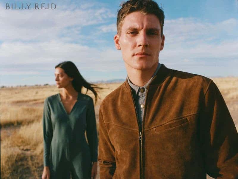 Two Billy Reid models standing in a field.