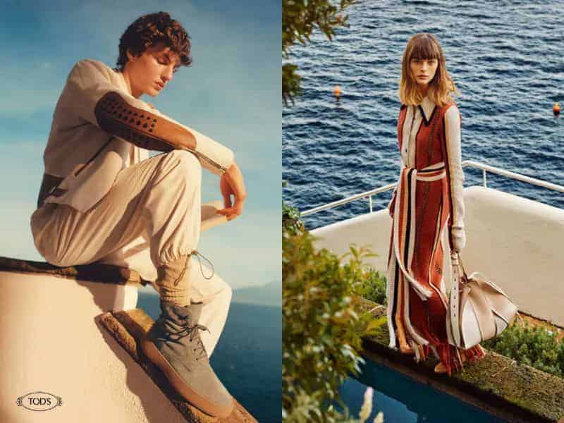 Two Tod's models posing outdoors near water.