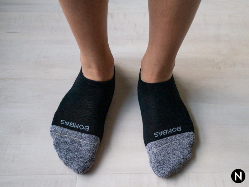 Person's legs wearing Bombas no-show socks.